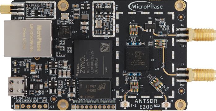 An ANTSDR E200 board: a bare circuit board carrying a Xilinx Zynq system-on-chip, an Ethernet jack, a USB-C connector and separate transmit and receive SMA sockets