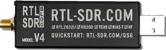 An RTL-SDR Blog V4 receiver: a black aluminium USB stick with an SMA antenna socket at one end